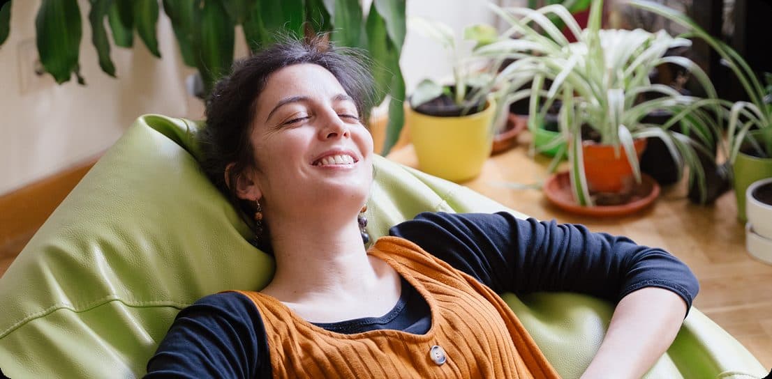 A person relaxing at home in natural light